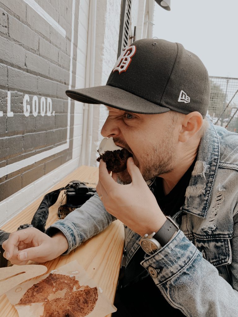 My husband eating the cupcake